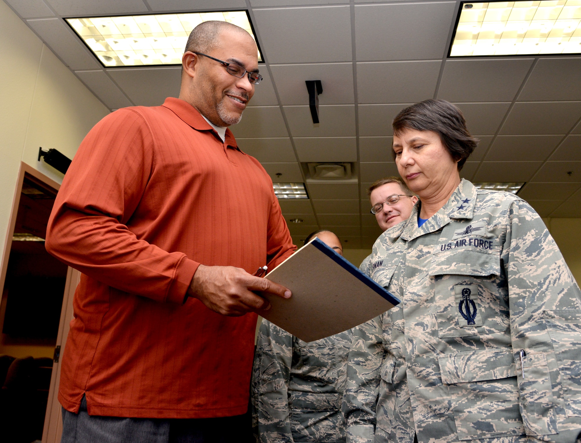 Jeffrey Fason, deputy team lead in the Air Force Nuclear Weapons Center's Applied Capabilities Office, shares results from an employee feedback survey with Maj. Gen. Sandra Finan, AFNWC commander. Fason is a part of the Force Improvement Program team, a program that provides a venue for employees to voice their concerns, raise issues, and provide possible solutions. (Photo by Todd Berenger) 
