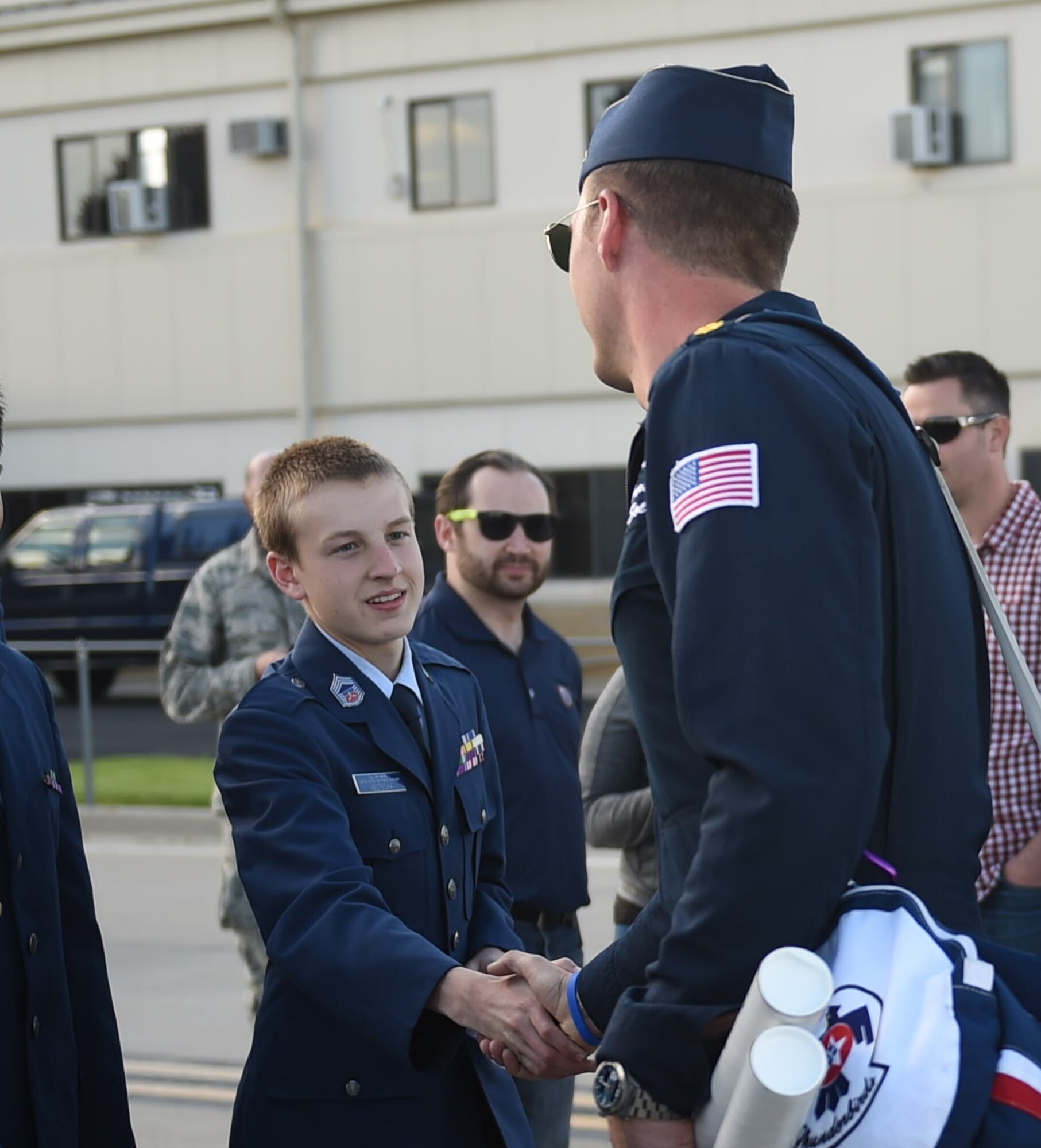 A Thunderbird demonstration pilot shakes the hand of a Civil Air Patrol cadet May 28, 2015, on the flight line on Buckley Air Force Base, Colo. The Thunderbirds team is staging out of Buckley AFB and will be performing in the 2015 Rocky Mountain Air Show May 30-31. (U.S. Air Force photo by Airman 1st Class Samantha Meadors/Released)