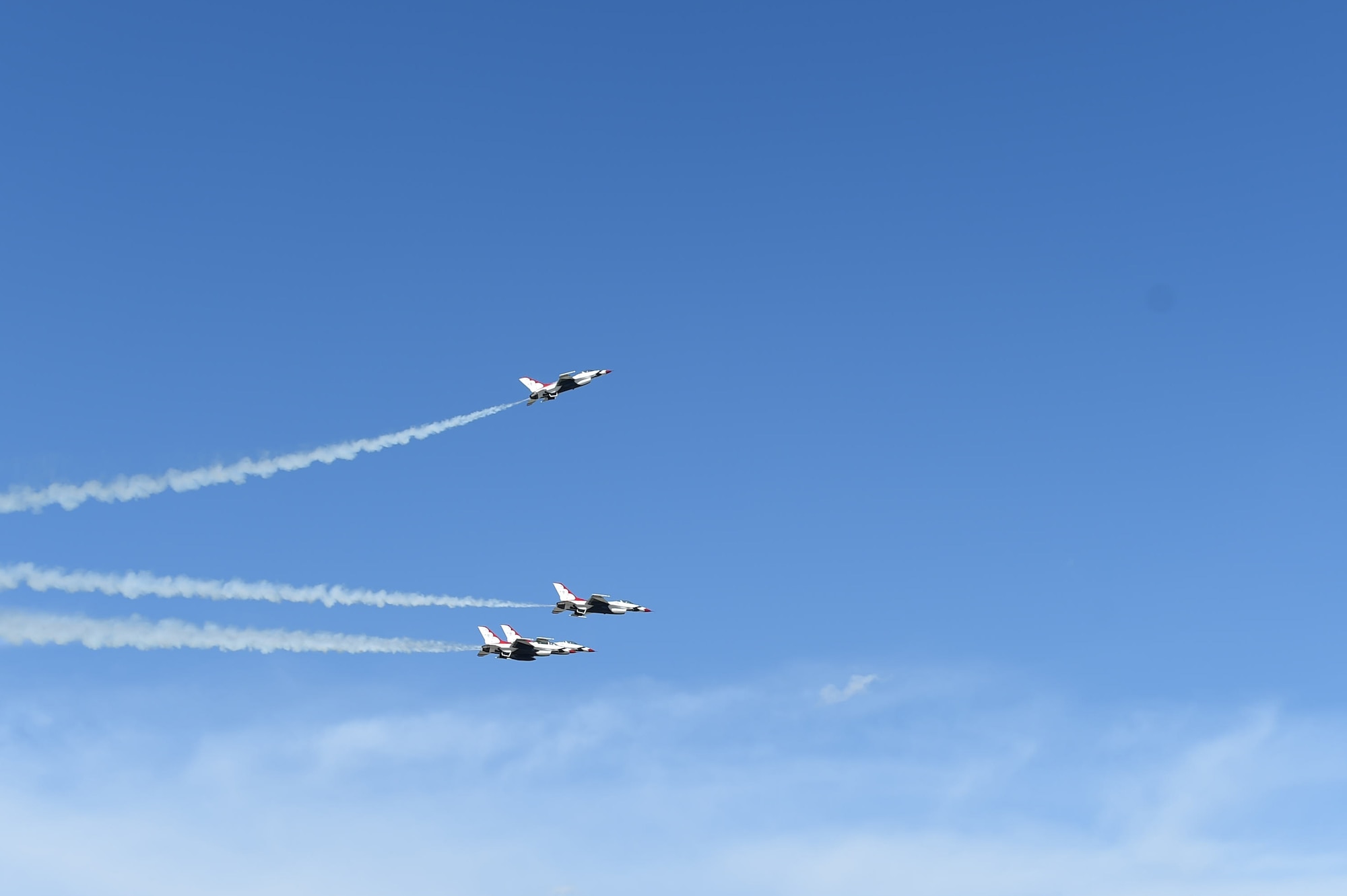 Three Thunderbirds jets fly over the flight line May 28, 2015, on Buckley Air Force Base, Colo. The team is staging out of Buckley AFB and will be performing in the 2015 Rocky Mountain Air Show May 30-31. (U.S. Air Force photo by Airman 1st Class Samantha Meadors/Released)
