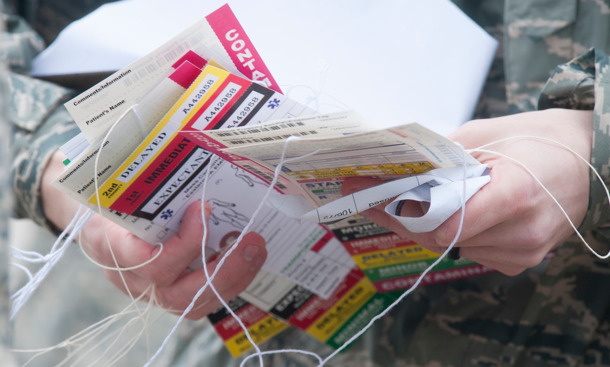 Tags used for identifying patient injuries are sorted by the members of the 509th Medical Group during a major accident response exercise May 20, 2015, at Whiteman Air Force Base, Mo. When responding to emergencies, properly identifying patient injuries is vital to positive identification and patient treatment. (U.S. Air Force photo by Staff Sgt. Brigitte N. Brantley/Released)