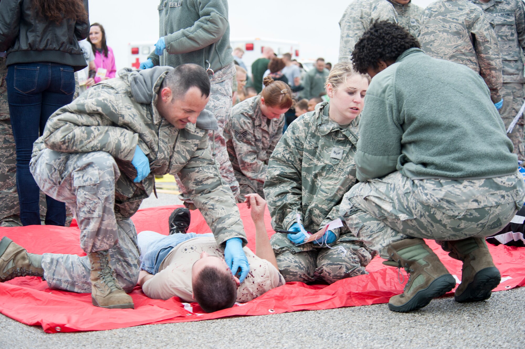 U.S. Air Force Capt. Marc Dunham, 509th Medical Operations Squadron nurse, applies pressure to the neck wound of a simulated patient during a major accident response exercise May 20, 2015, at Whiteman Air Force Base, Mo. Although he typically works in the Personnel Reliability Program clinic, Dunham was part of the response team because major accidents require all medics to work together to treat patients. (U.S. Air Force photo by Staff Sgt. Brigitte N. Brantley/Released)