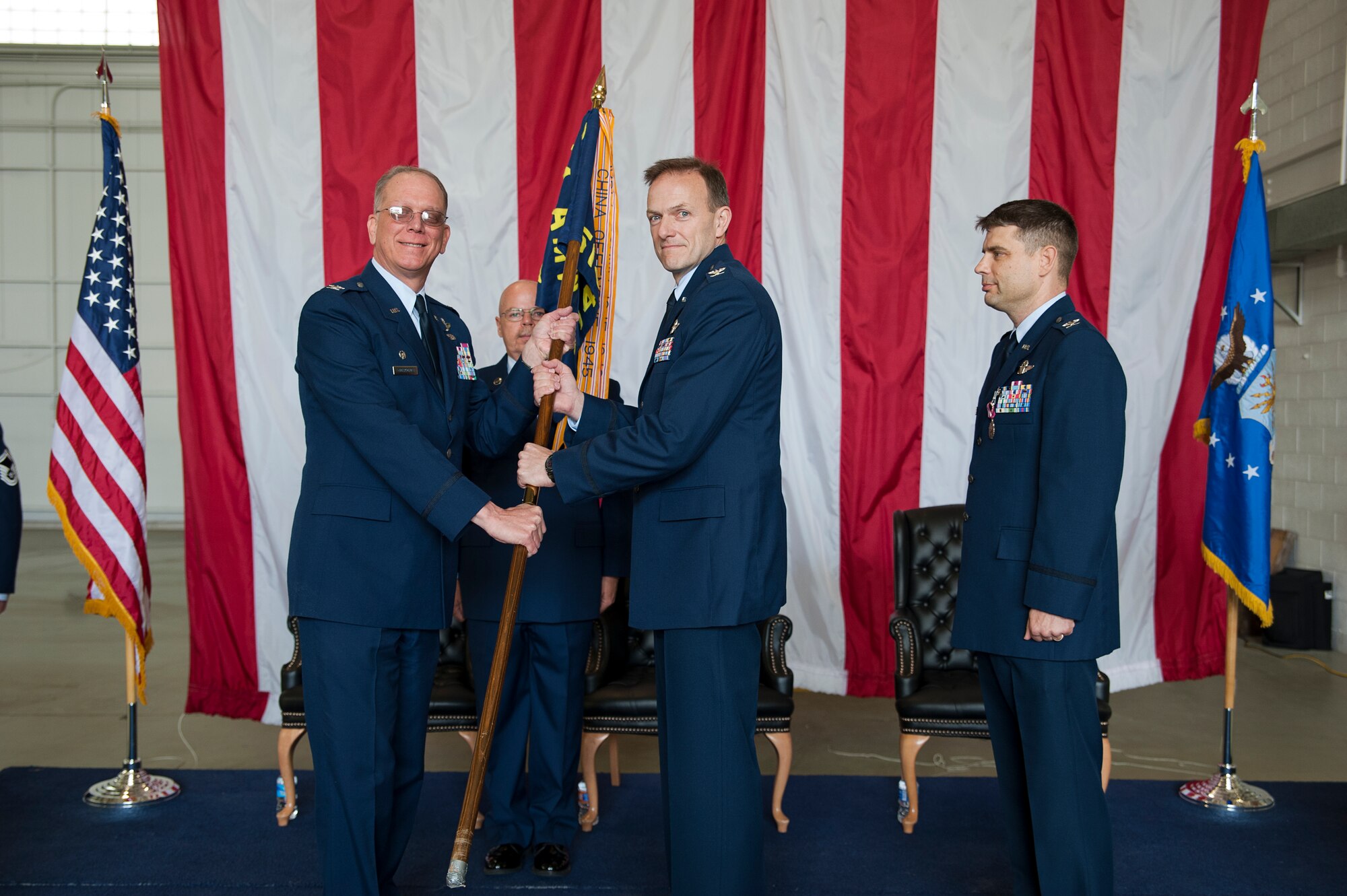 Col. Robert Dunham takes the guidon from Col. Underkofler, assuming command of the operations group. Dunham was previously the director of the Air Force operations center at the Pentagon, Arlington, Va.