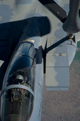Tech. Sgt. Eric Flanders, 92nd Air Refueling Squadron boom operator, and Airman 1st Class Erica Mann, 92nd ARS boom operator, make a boom connection to an F-15C, flying out of the 173rd Fighter Wing, Kingsley Field Air National Guard Base, Klamath Falls, Ore., during an air refueling mission and incentive flight on board a 92nd Air Refueling Wing KC-135 Stratotanker over Oregon, May 27, 2015. The incentive flight is a program that gives Fairchild Airmen a chance to see the air refueling mission first hand. The Airmen are handpicked based off their work performance. (U.S. Air Force photo/Airman 1st Class Nicolo J. Daniello) 
