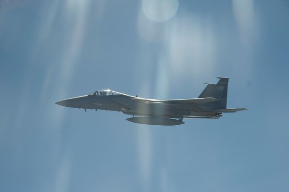 An F-15C, flying out of the 173rd Fighter Wing, Kingsley Field Air National Guard Base, Klamath Falls, Ore., begins a wingtip formation while his comrades are refueled by a KC-135 Stratotanker May 27, 2015, over Oregon. The incentive flight enables Airmen to see the air refueling mission that Fairchild provides to the Department of Defense. (U.S. Air Force photo/Airman 1st Class Nicolo J. Daniello) 
