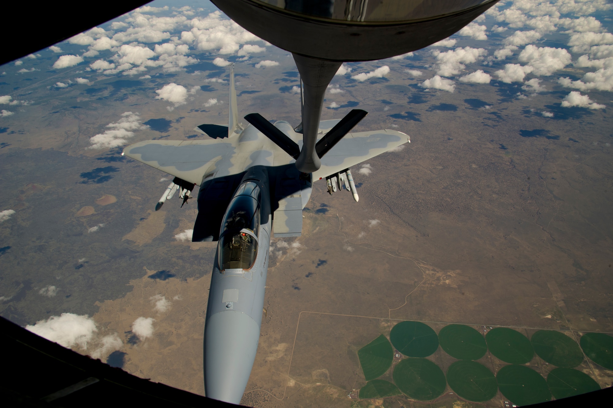 Tech. Sgt. Eric Flanders, 92nd Air Refueling Squadron boom operator, and Airman 1st Class Erica Mann, 92nd ARS boom operator, makes a boom connection to an F-15C, flying out of the 173rd Fighter Wing, Kingsley Field Air National Guard Base, Klamath Falls Oregon, during an air refueling mission and incentive flight on board a 92nd Air Refueling Wing KC-135 Stratotanker over Oregon, May 27, 2015. The incentive flight gave Airmen the opportunity to see how the boom operators complete the air refueling mission of Fairchild. (U.S. Air Force photo/Airman 1st Class Nicolo J. Daniello)