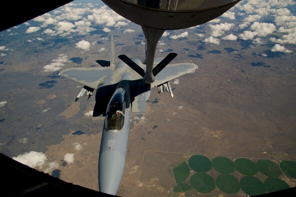 Tech. Sgt. Eric Flanders, 92nd Air Refueling Squadron boom operator, and Airman 1st Class Erica Mann, 92nd ARS boom operator, make a boom connection to an F-15C, flying out of the 173rd Fighter Wing, Kingsley Field Air National Guard Base, Klamath Falls, Ore., during an air refueling mission and incentive flight on board a 92nd Air Refueling Wing KC-135 Stratotanker over Oregon, May 27, 2015. During the incentive flight, Airmen witnessed boom operators complete the air refueling mission of Fairchild. (U.S. Air Force photo/Airman 1st Class Nicolo J. Daniello) 
