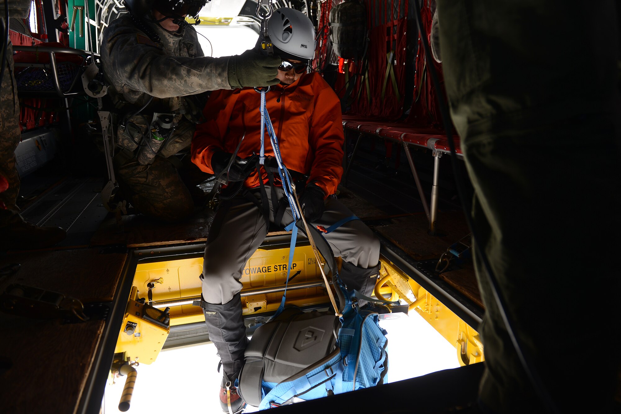 Master Sgt. Kim-Xuan Brewer, 22nd STS tactical air control party, prepares to be lowered on to Mount Rainer, Wash., May 15, 2015.  Brewer was completing annual mountain rescue training. (U.S. Air Force photo by Staff Sgt. Tim Chacon)