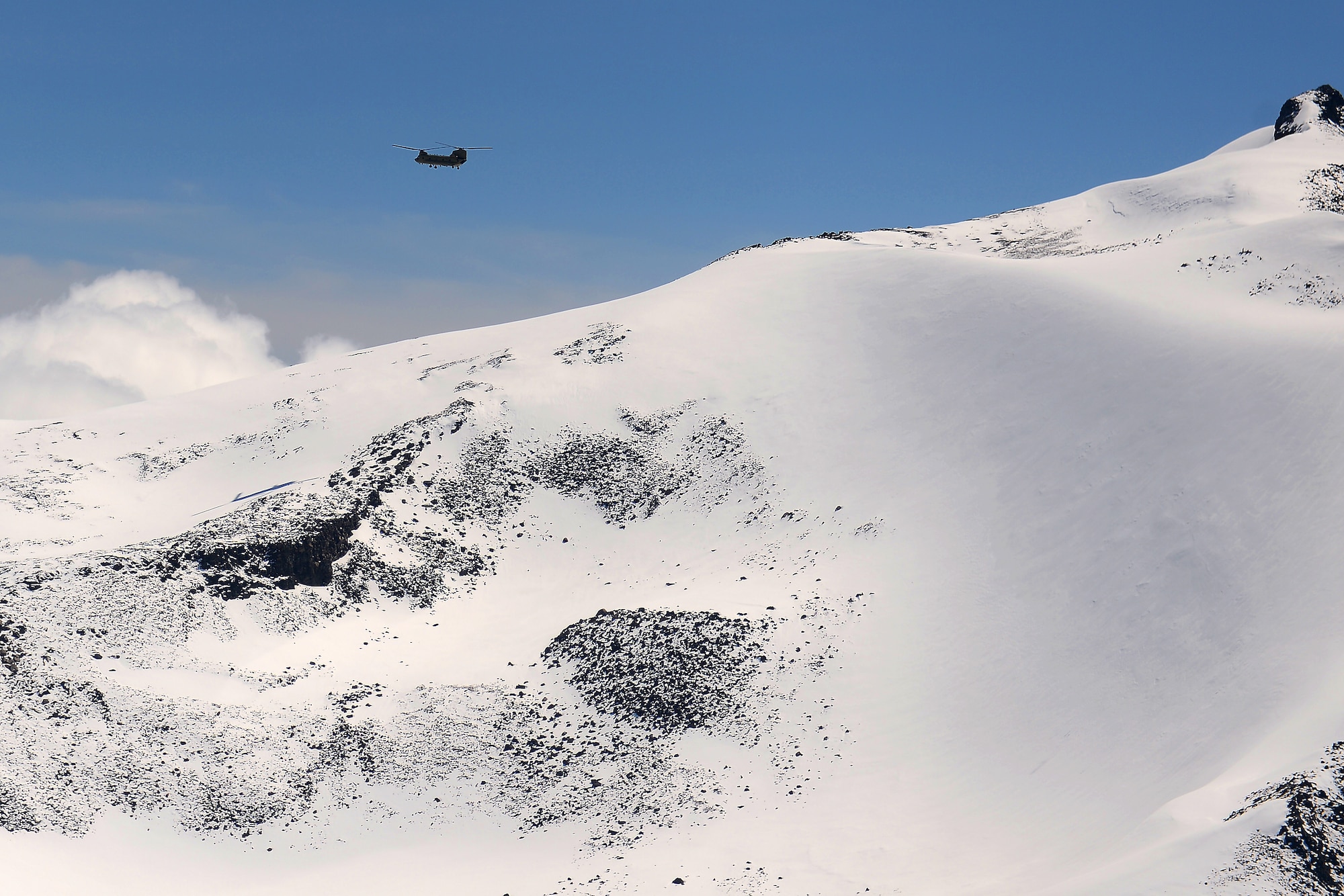 A CH-47 Chinook from Bravo Co. 1-214th Aviation Regiment hovers over Mount Rainer, Wash., May 15, 2015. The 214th AR provides transport for 22nd Special Tactics Squadron Airmen doing rescue operations on Mount Rainer. 
