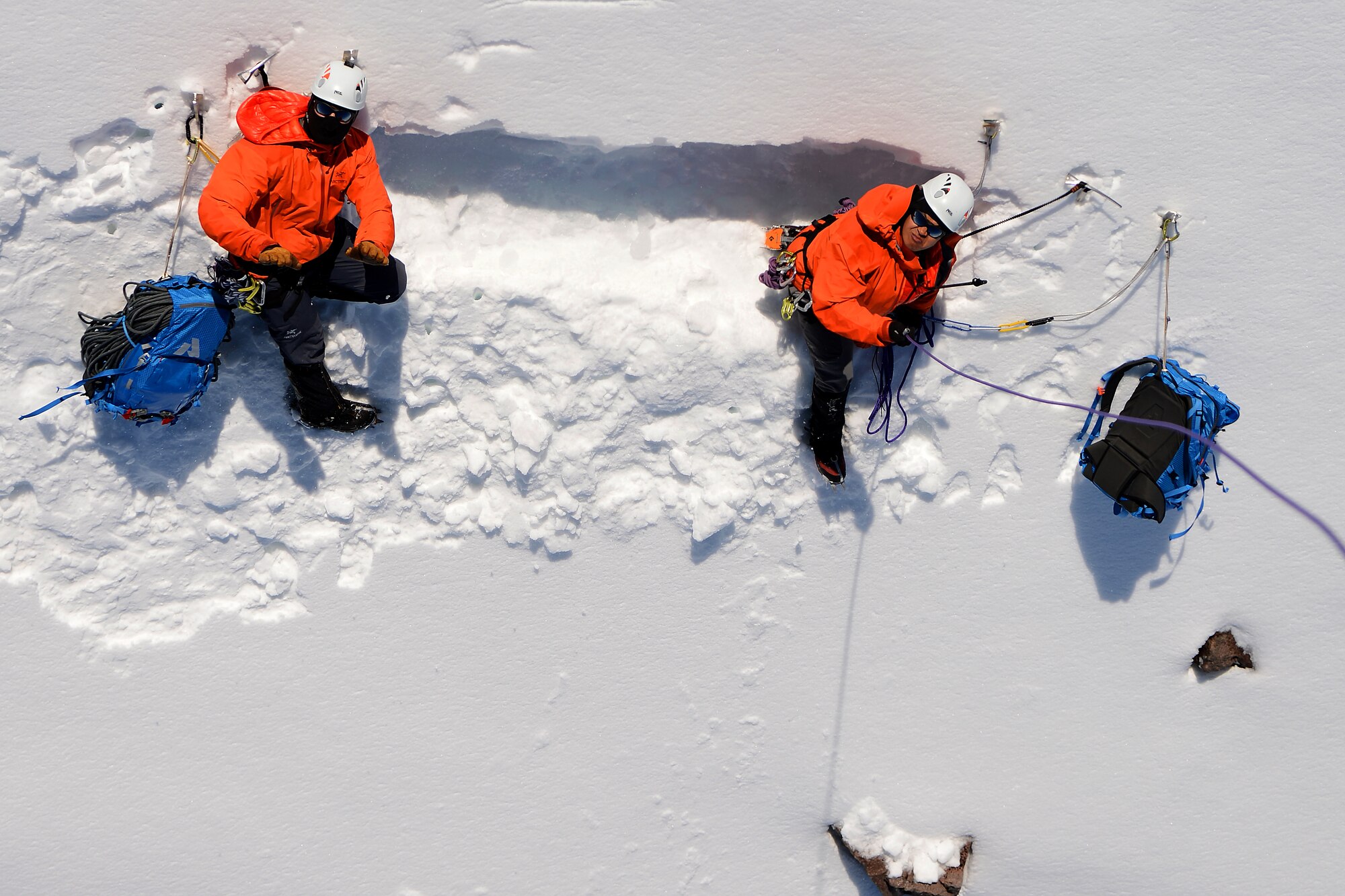 Tech. Sgt. Dean Criswell (left), 22nd Special Tactics Squadron NCOIC of rescue operations, and Master Sgt. Kim-Xuan Brewer, 22nd STS tactical air control party, dig into the side of Mount Rainer, Wash., May 15, 2015.  Criswell and Brewer were conducting annual mountain rescue training. (U.S. Air Force photo by Staff Sgt. Tim Chacon) 
