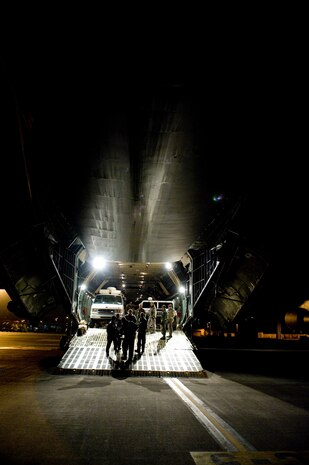 Airmen from the 137th Airlift Squadron, New York Air National Guard, and Marines from the initial response force unload equipment from a C-5 Galaxy at Yokota Air Base April 3, 2011. After the March 11 earthquake off the Japanese coast, Airmen from Air Mobility Command, Pacific Air Forces joined a team of responders to bring humanitarian assistance and disaster relief - Operation TOMODACHI - and fly DoD voluntary returnees and their loved ones back to the U.S - Operation PACIFIC PASSAGE.  (U.S. Air Force phot BY/Master Sgt. Jeromy K. Cross)