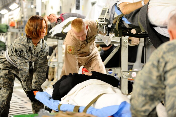 Senior Airman Samantha Brunner, a 332nd Expeditionary Aerospace Medical Squadron aerospace medical service journeyman, helps rack a patient onto a C-17 Globemaster III aircraft at Joint Base Balad, Iraq, Nov. 27, 2008, during an aeromedical evacuation mission in support of Operation IRAQI FREEDOM. Air Mobility Command performed patient movements non-stop since OIF began, transporting more than 150,000 patients to critical medical care. AMC’s aeromedical evacuation efforts increased the odds of surviving a combat injury to approximately 98 percent by expediting the return of wounded servicemembers to the U.S. within three days or less (U.S. Air Force photo by Airman 1st Class Jason Epley). 