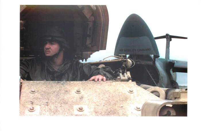 Private First Class Monday of the 24th Infantry Division, Fort Stewart, Georgia, waits to load his Bradley M2-A2 fighting vehicles onto a C-5 Galaxy Oct. 7, 1993. The C-5 transported transport the M2-A2s from Hunter Army Airfield, Georgia to Mogadishu, Somalia in support of Operation RESTORE HOPE. During the operation, Air Mobility Command airlifters delivered food, medicine, logistical support and other cargo to Somalia, while AMC tankers built an “airbridge” over the Atlantic to keep supplies flowing.  (U.S. Air Force Photo by Airman First Class Jeffrey Allen)