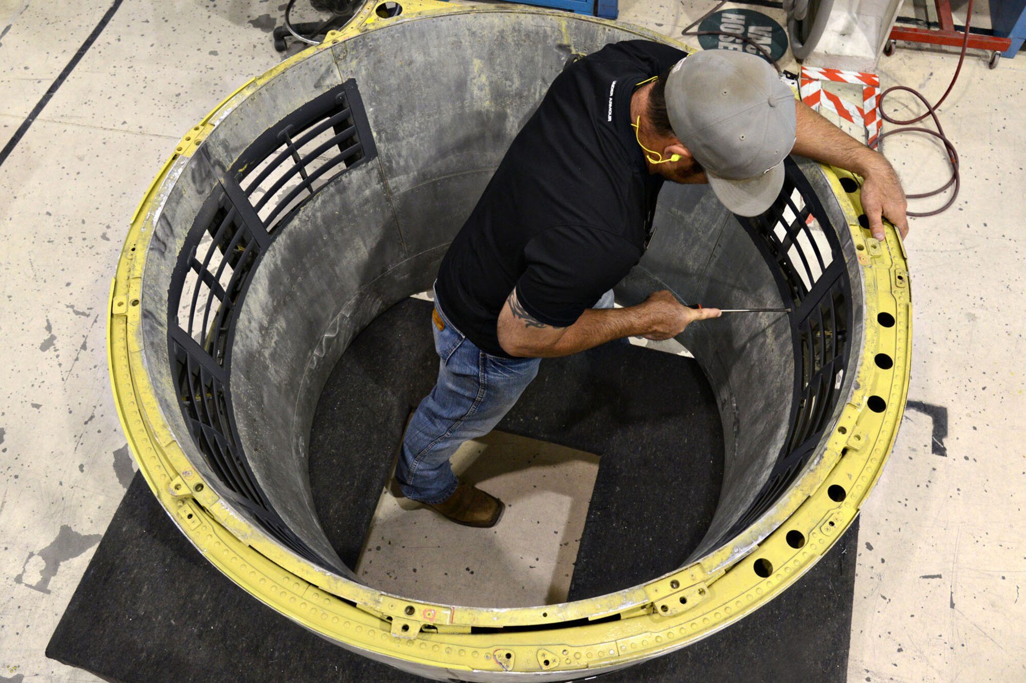 The Commodities Maintenance Group’s B-52 Nose Cowls shop, since switching to a modular process in 2010, has diminished its flow days from 140 down to almost 40 days. The shop averages 33 cowlings per quarter and they currently have zero days for back orders and awaiting parts days due to the success of the process. Sheetmetal mechanic David Carter, with the 551CMXG, works on one of the nose cowls. (Air Force photo by Kelly White/Released)