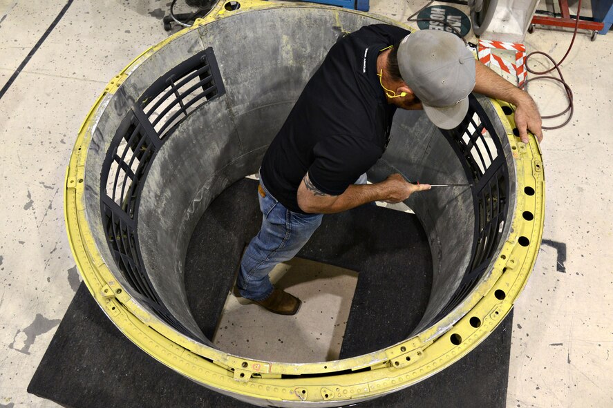 The Commodities Maintenance Group’s B-52 Nose Cowls shop, since switching to a modular process in 2010, has diminished its flow days from 140 down to almost 40 days. The shop averages 33 cowlings per quarter and they currently have zero days for back orders and awaiting parts days due to the success of the process. Sheetmetal mechanic David Carter, with the 551CMXG, works on one of the nose cowls. (Air Force photo by Kelly White/Released)