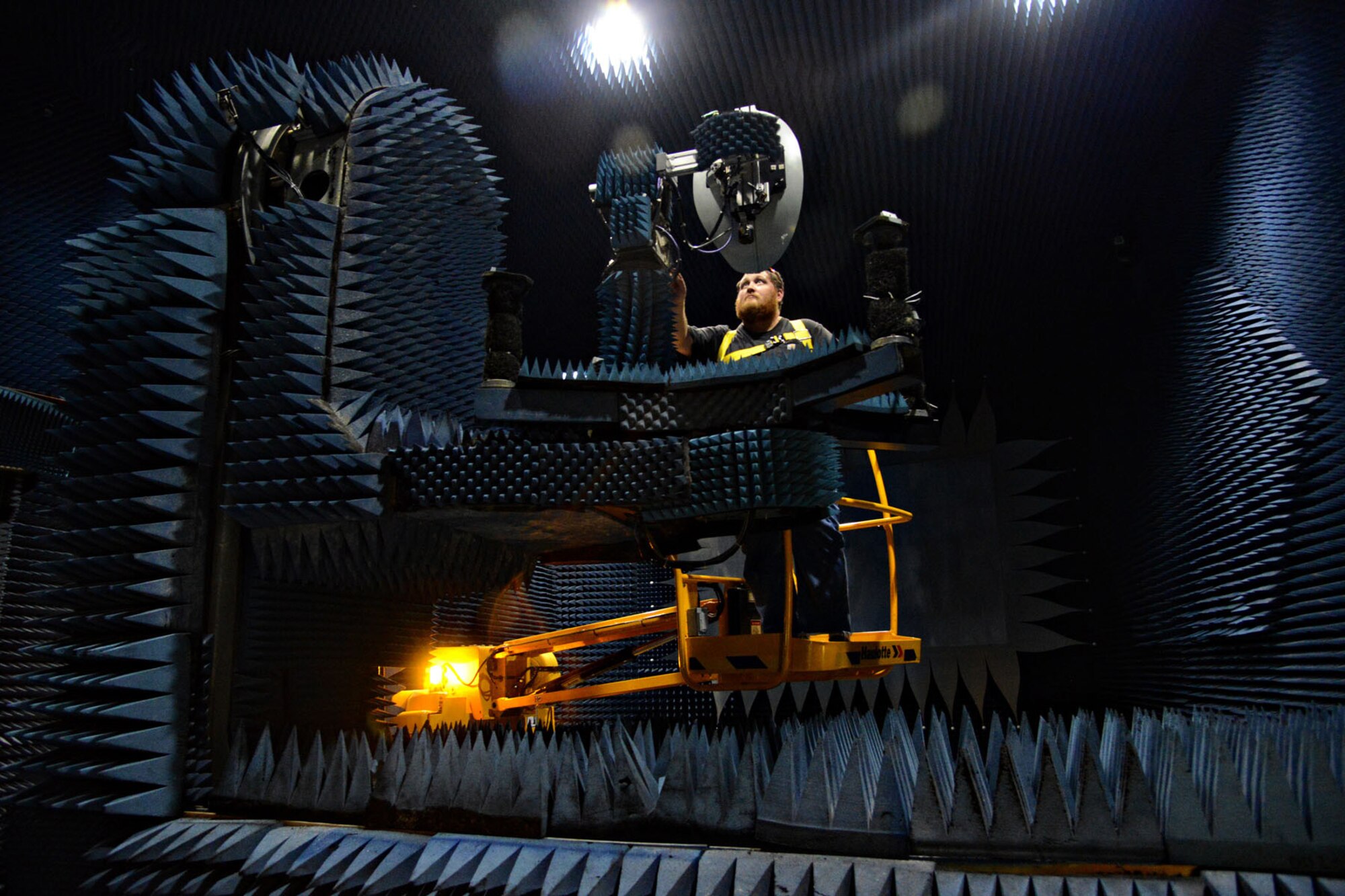 Electronics mechanic J.D. Drake, with the 550th Commodities Maintenance Squadron, checks the equipment in Building 3707’s compact range. Commodities has four compact ranges on base. This one performs electrical tests on KC-135 variant nose radomes. (Air Force photo by Kelly White/Released)