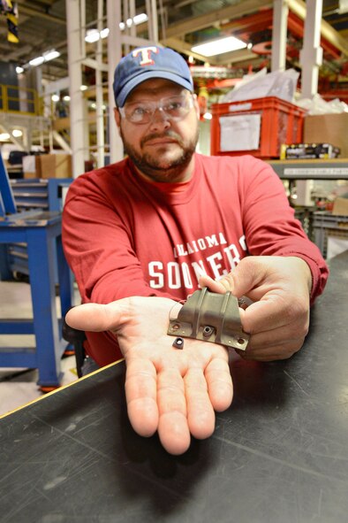 Scott Whitmore, a parts reworker with the 545th Propulsion Maintenance Group, saved the government approximately $77,000 by reworking the clinch nut on a bumper bracket for the 220F100 engine core. His simple fix is now incorporated into the tech data for this part. (Air Force photo by Kelly White/Released)
