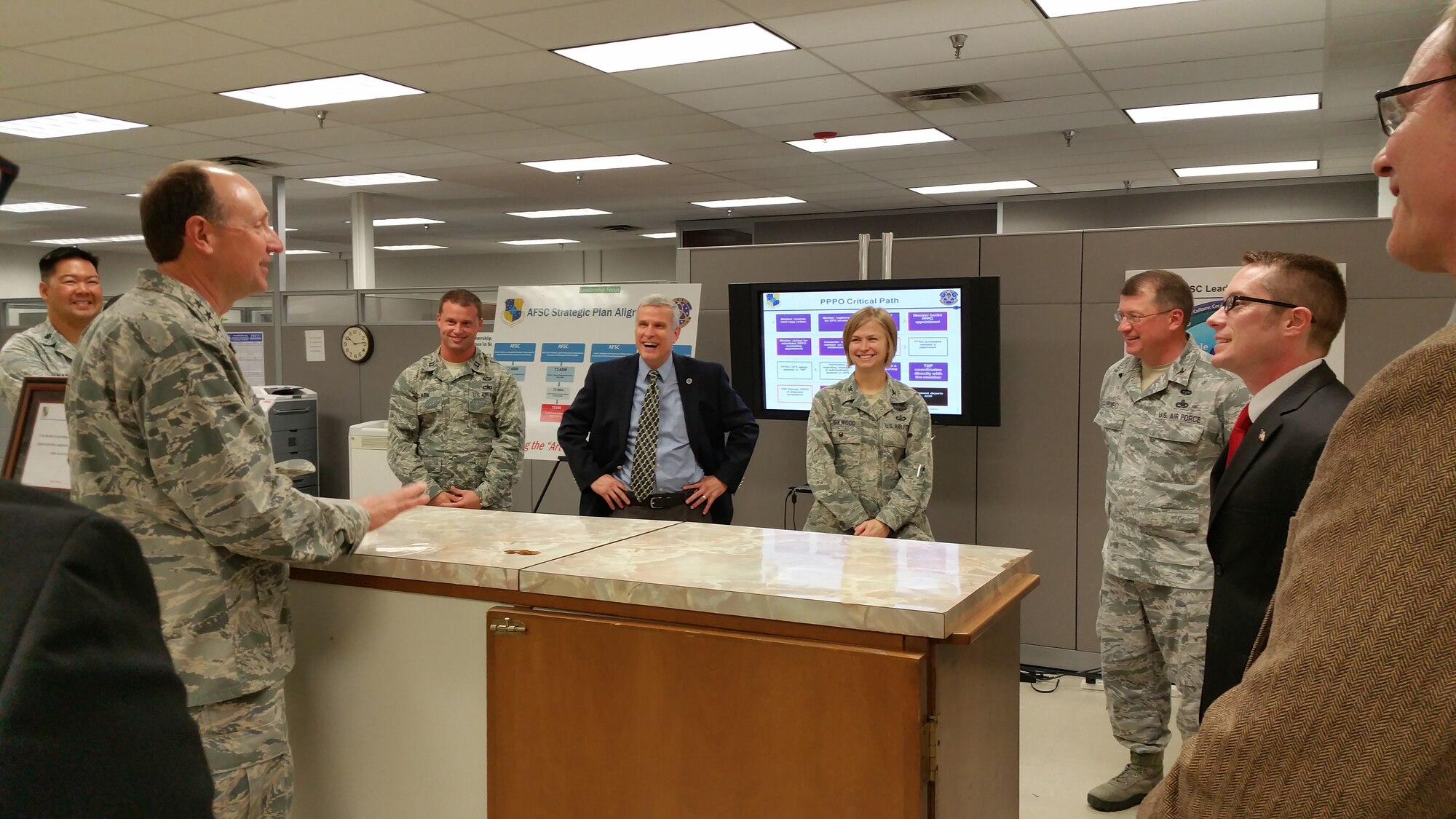 Visiting the Personal Property Processing Office are, from left, Lt. Col. Gerald Yap, 72nd Mission Support Group deputy commander; Lt. Gen. Bruce Litchfield, AFSC commander; Capt. Christopher Clark, AFSC executive officer; Stephen Walker, 72nd Logistics Readiness Squadron director; Col. Lea Kirkwood, 72nd Air Base Wing vice commander; Col. John Kubinec, AFSC vice commander; Christopher Fellows, 72nd LRS lead traffic management specialist; and Larry Yeley, 72nd LRS Personal Property Section chief.  (Air Force photo by Airman 1st Class Timothy Stephens/Released)

