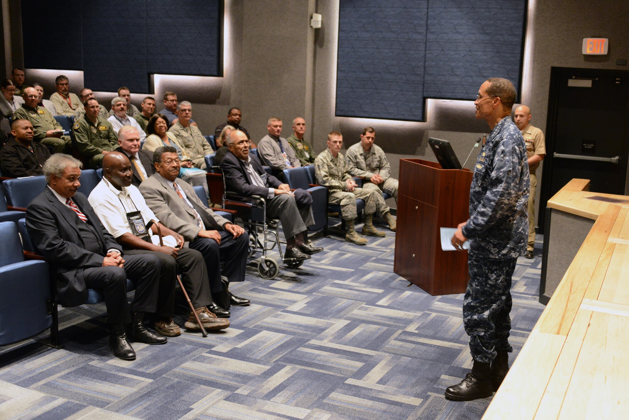 U.S. Navy Adm. Cecil D. Haney (standing right), U.S. Strategic Command commander, introduces former U.S. Army Air Corps Cpl. Robert D. Holts (front row, third from right), an original Tuskegee Airman, and representatives from the Alfonza W. Davis Chapter of Tuskegee Airmen Inc. during their visit to USSTRATCOM headquarters, Offutt Air Force Base, Neb., May 26, 2015. The delegation shared information about their organization, told stories about Holts' experience in the Army Air Corps and answered questions from the audience. Holts, the last known surviving Tuskegee Airman from Nebraska, was sworn into service at Fort Crook, now Offutt AFB, in 1942 and served as a drafting engineer and logistics specialist until 1946. The term "Tuskegee Airmen" refers to everyone - to include men and women, African Americans and Caucasians - involved in the "Tuskegee Experience," the Army Air Corps program to train African Americans to fly and maintain combat aircraft. Contrary to popular belief, this includes not just pilots, but navigators, bombardiers, maintenance support staff, instructors and all personnel who kept the planes in the air. USSTRATCOM is one of nine DOD unified combatant commands and is charged with strategic deterrence; space operations; cyberspace operations; joint electronic warfare; global strike; missile defense; intelligence, surveillance and reconnaissance; combating weapons of mass destruction; and analysis and targeting. (USSTRATCOM photo by U.S. Air Force Staff Sgt. Jonathan Lovelady/Released)