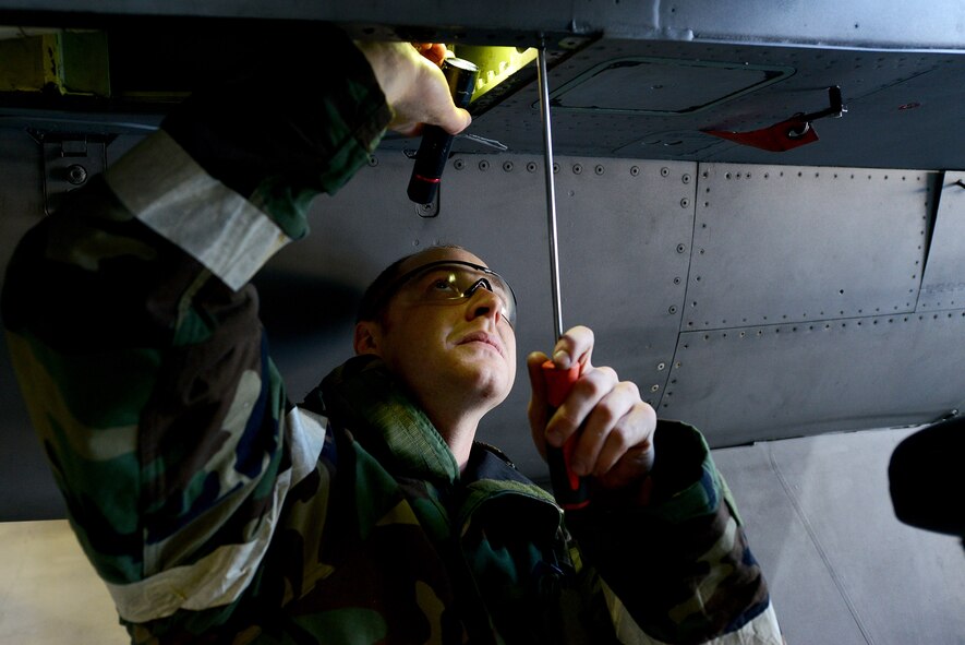 U.S. Air Force Airman 1st Class Gage Moak, 20th Equipment Maintenance Squadron phase inspection team member, repairs an F-16CM Fighting Falcon during operational readiness exercise Weasel Victory 15-06 at Shaw Air Force Base, S.C., May 28, 2015. During an ORE, Airmen are tasked with performing their duties in a simulated deployed environment. (U.S. Air Force photo by Senior Airman Diana M. Cossaboom/Released)