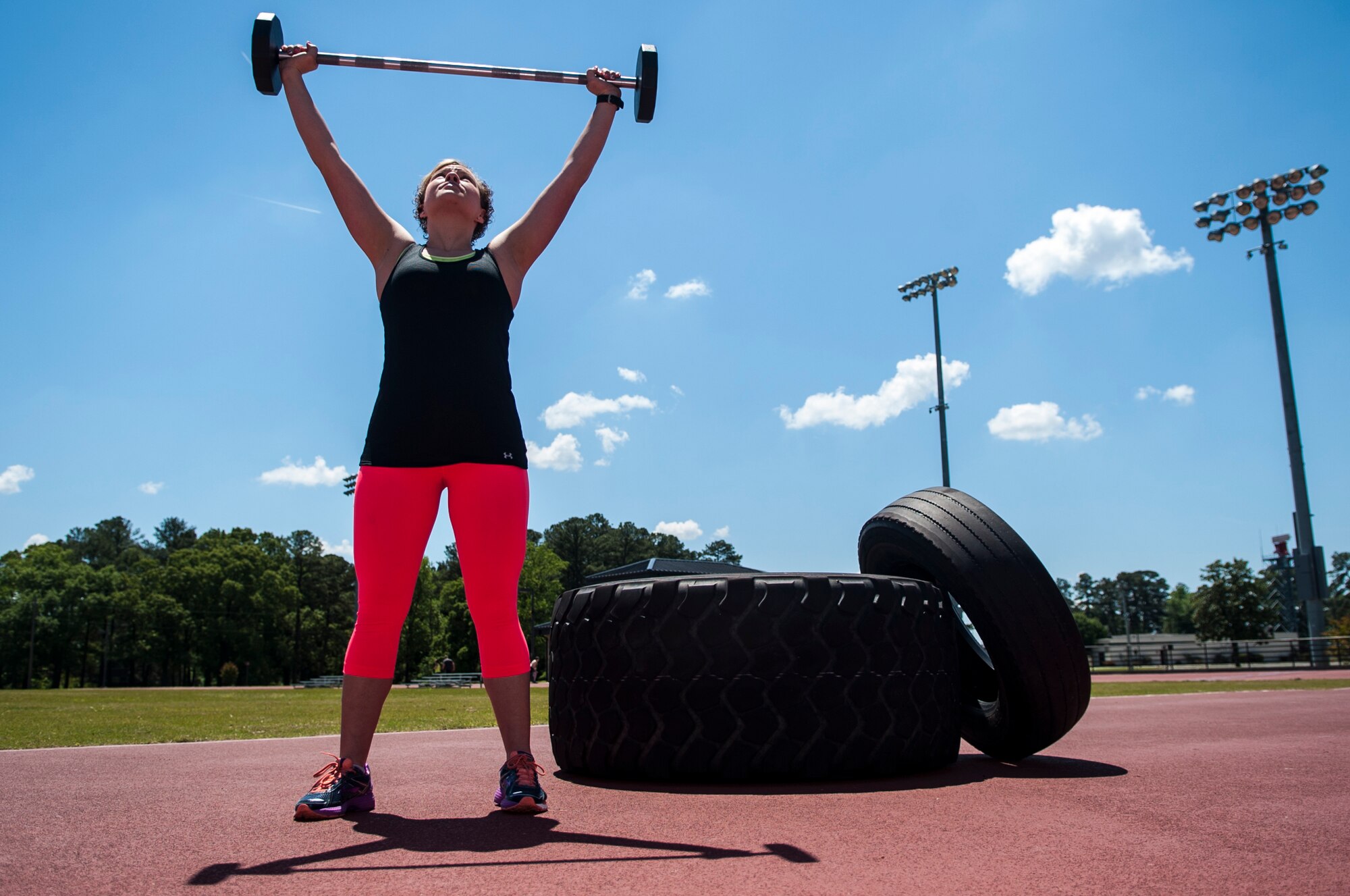 Sara Bellomy lifts a bar bell, May 3, 2015, at Seymour Johnson Air Force Base, North Carolina. Bellomy, who two years ago weighed 221 pounds and wore a size 17/18, now weighs 160 pounds and wears a size 5/6. (U.S. Air Force photo/Airman Shawna L. Keyes)