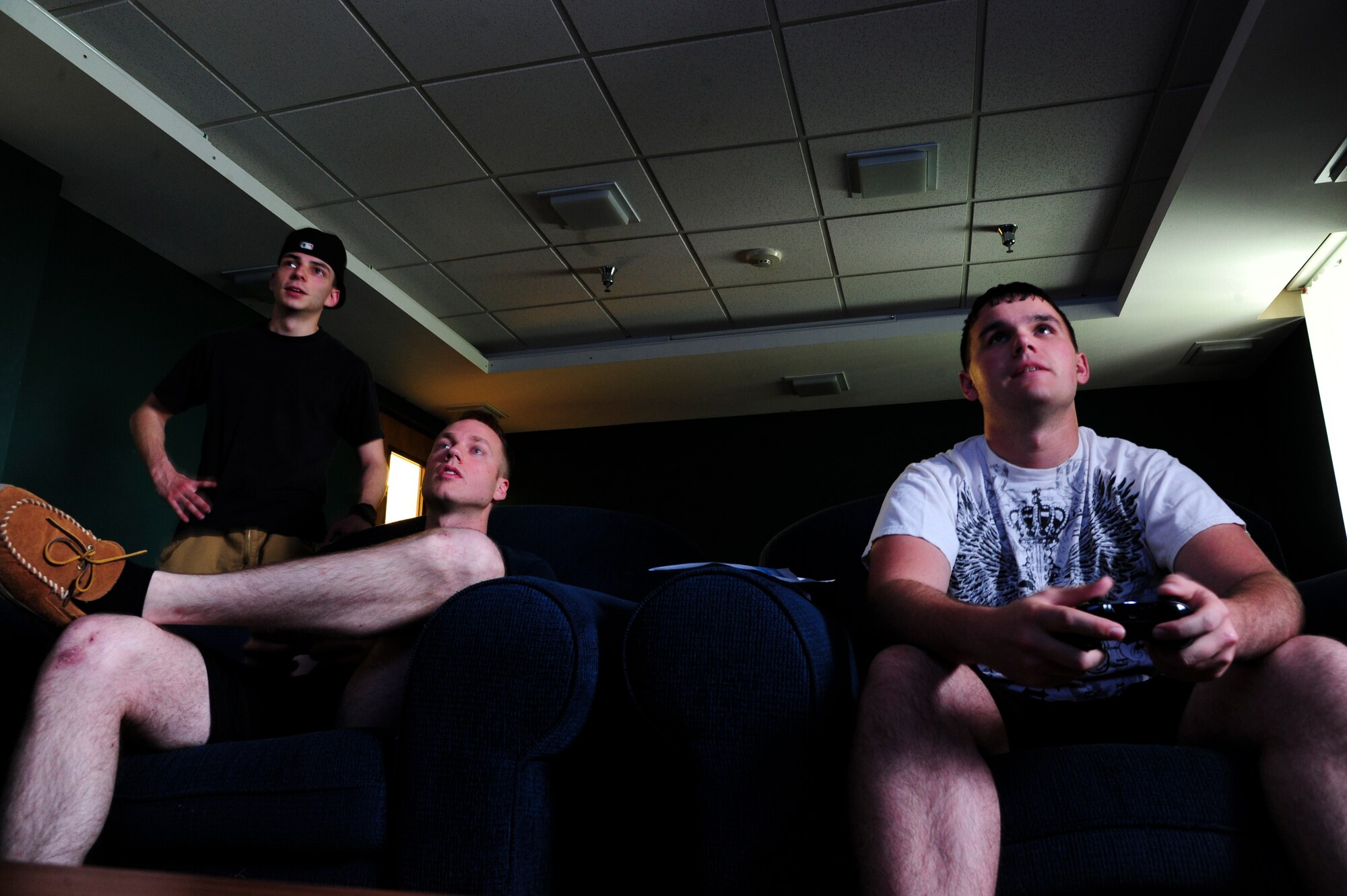Airman John Greenberg, 319th Logistics Readiness Squadron vehicle operator apprentice, left, Airman 1st Class Scott Mattes, 69th Maintenance Squadron ground systems technician, middle, and Airman 1st Class Jeremy Kvigne, 69th MXS ground systems technician, concentrate during a round of Call of Duty: Advanced Warfare May 28, 2015 in the dormitory dayroom on Grand Forks Air Force Base, N.D. Gaming has become a popular way for Airmen to connect outside of duty hours. (U.S. Air Force photo by Airman 1st Class Ryan Sparks/released)