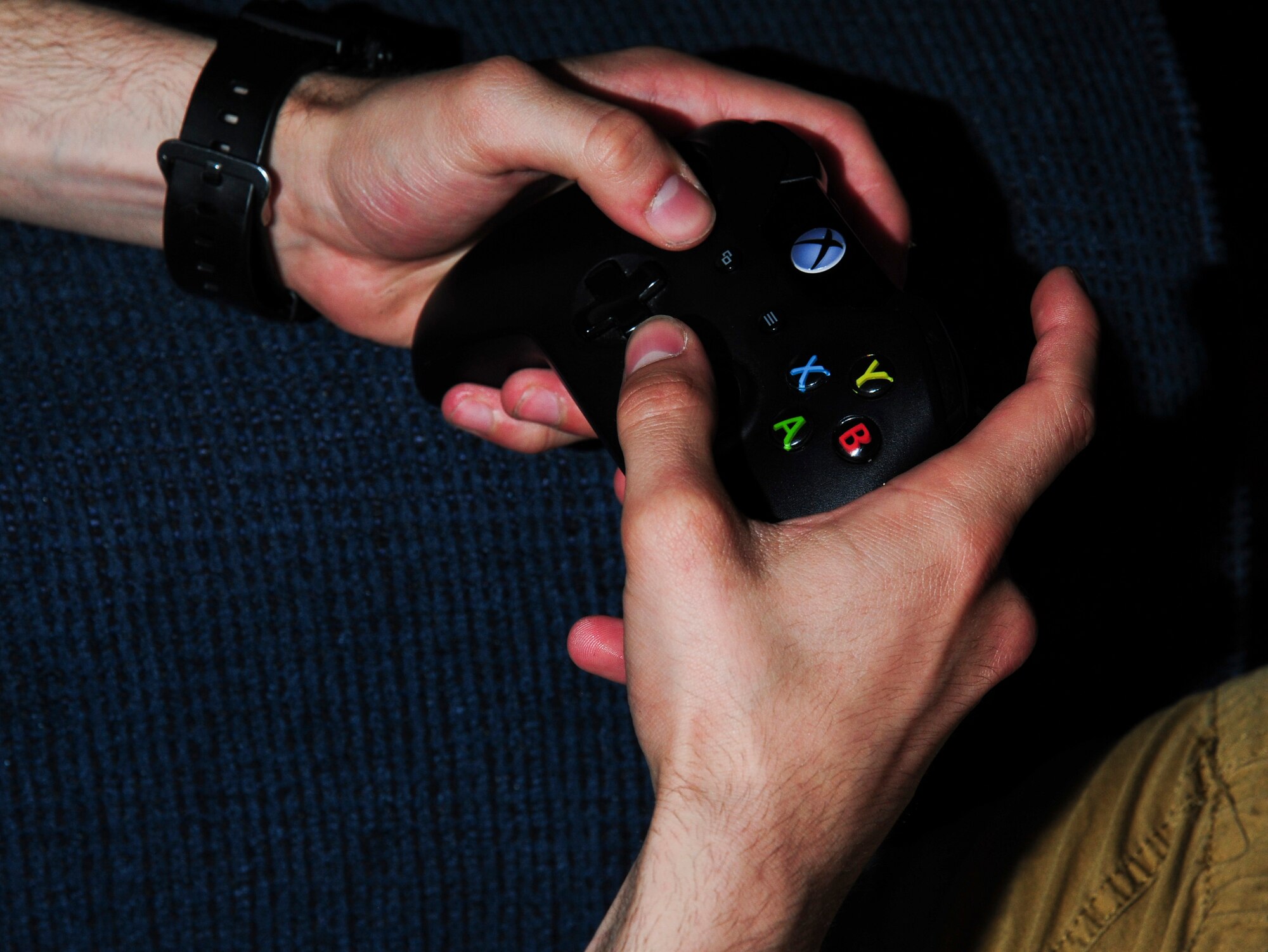 A Grand Forks Air Force Base Airman handles an Xbox One controller May 28, 2015, in a dormitory dayroom on Grand Forks Air Force Base, N.D. Gaming has become a popular way for Airmen to connect outside of duty hours. Video games test the gamer’s hand-eye coordination and provide an alternative to outdoor activities. (U.S. Air Force photo by Airman 1st Class Ryan Sparks/released)