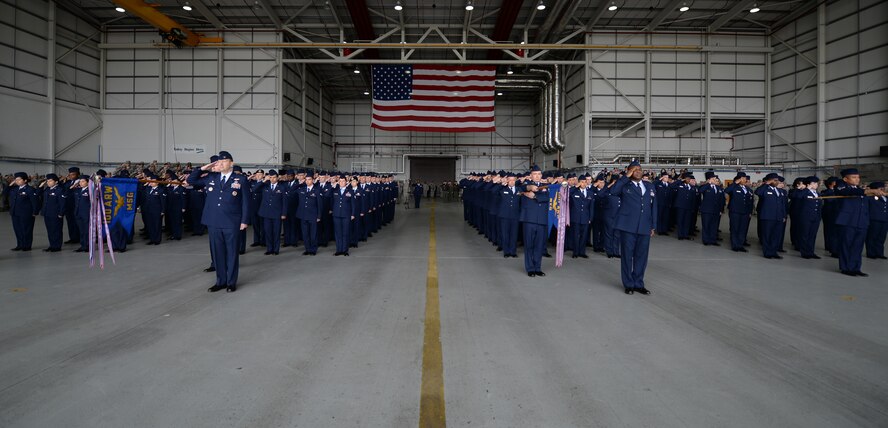 U.S. Air Force 100th Air Refueling Wing Airmen salute in formation during the 100th ARW change of command ceremony May 29, 2015, on RAF Mildenhall, England. During the ceremony, Col. Kenneth T. Bibb, Jr., outgoing 100th ARW commander, relinquished command and Torkelson, 100th ARW commander, assumed authority. (U.S. Air Force photo by Senior Airman Kyla Gifford/Released)