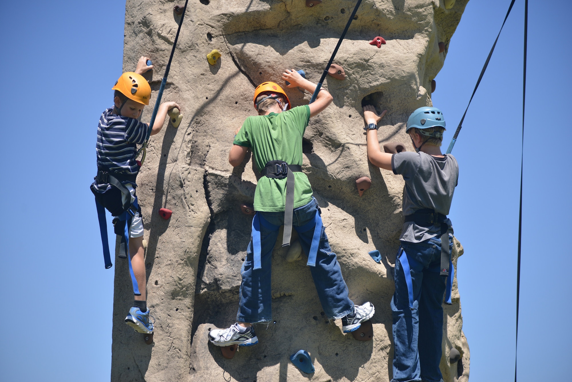 Kids enjoy a climbing wall at the 2014 Summer Bash. In addition to a climbing wall, this year's bash will also have static aircraft displays, craft displays, door prizes, vendors and more. (Photo by Todd Berenger)
