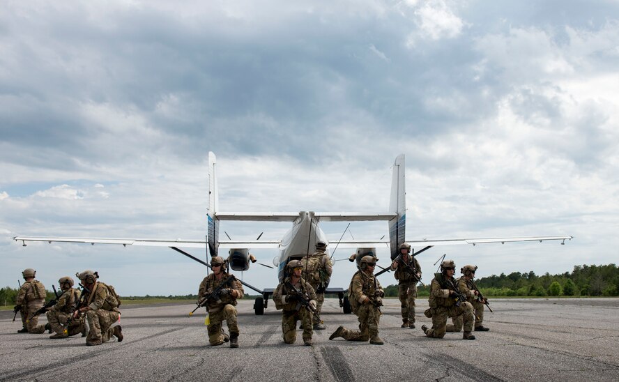 Special Tactics Airmen from the Special Tactics Training Squadron, 24th Special Operations Wing, Hurlburt Field, Fla., secure the runway to load a passenger in the back of a Duke Field C-145 at Eglin Range, Fla., April 23, 2015. The STTS delivers advanced and special tactics skills to a wide variety of joint special operations career fields, including combat controllers and special tactics pararescuemen. (U.S. Air Force photo/ Tech. Sgt. Jasmin Taylor)