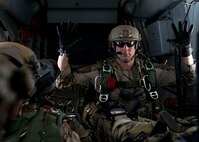 The jumpmaster from the Special Tactics Training Squadron, 24th Special Operations Wing, Hurlburt Field, Fla., gives the ten minute warning in the back of a Duke Field C-145 before the team’s free-fall at Eglin Range, Fla., April 23, 2015. The STTS delivers advanced and special tactics skills to a wide variety of joint special operations career fields, including combat controllers and special tactics pararescuemen. (U.S. Air Force photo/ Tech. Sgt. Jasmin Taylor)