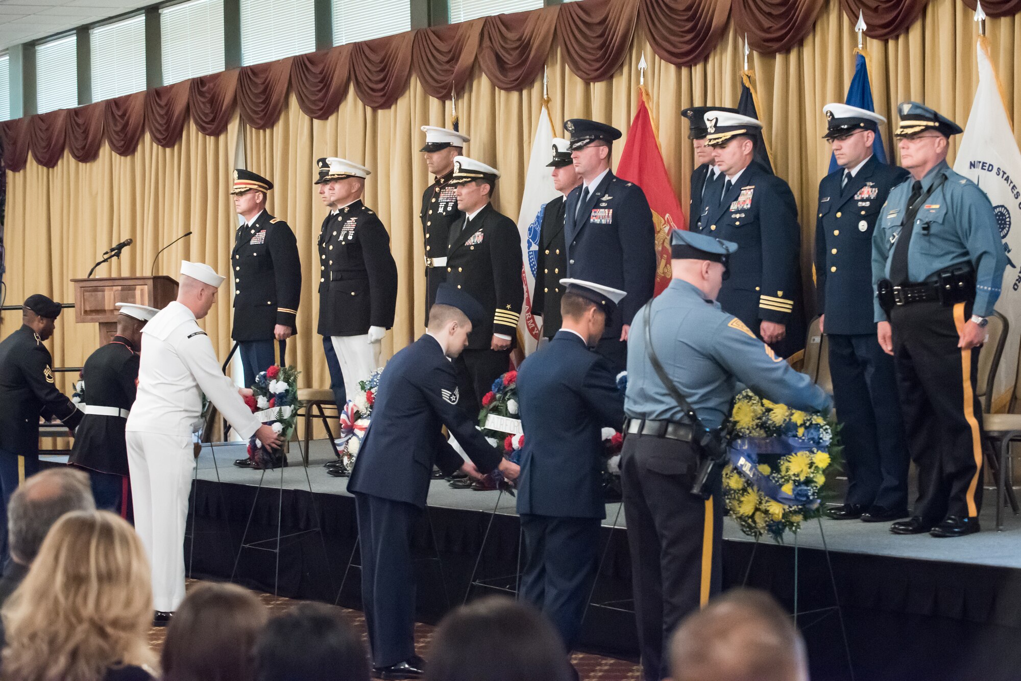 Local law enforcement and joint base leaders stand at attention as wreaths are presented during the 33rd Annual Parade of Wreaths honoring our fallen warriors May 21, 2015, at Tommy B’s Community Activities Center. Military, community and law enforcement members laid more than 30 wreaths in tribute to those who made the ultimate sacrifice. (U.S. Air Force photo by Russell Meseroll/Released)