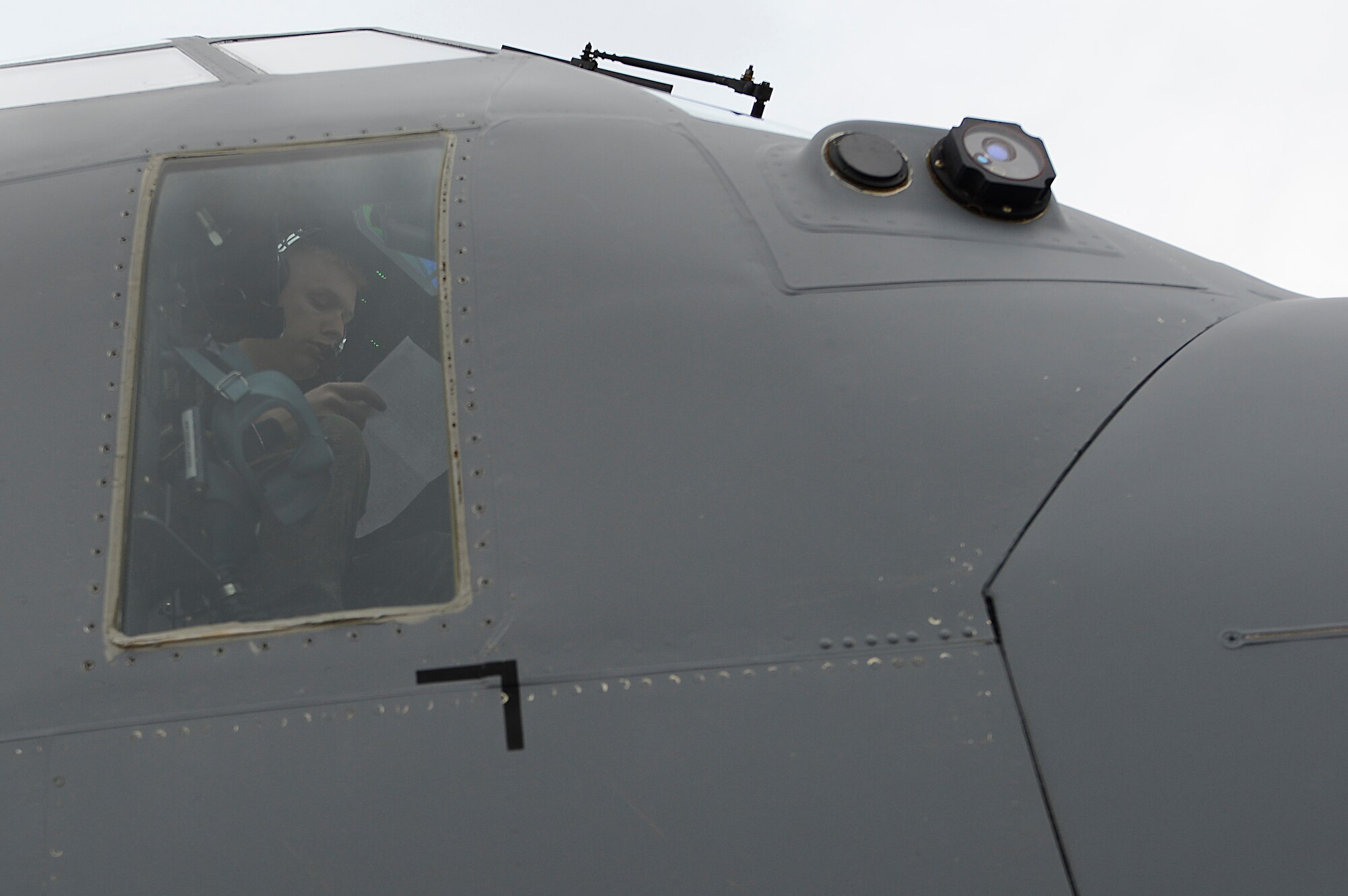 Capt. Kirk Habrun, 37th Airlift Squadron pilot, prepares for a flight to Kosovo to perform an airdrop training exercise May 27, 2015, at Ramstein Air Base, Germany. The exercise consisted of dropping four pallets of nutrition supplies to Kosovo. (U.S. Air Force photo/Airman 1st Class Tryphena Mayhugh)