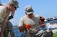 U.S. Air Force Tech. Sgt. Brian Wright, left, watches as Airman 1st Class Kristofer Flores solders two copper pipes together that will be connected to an air conditioning unit that is being installed at Coast Guard Sector St. Petersburg, Fla., on May 26, 2015. Wright and Flores, with the  New Jersey Air National Guard’s 177th Civil Engineering HVAC shop, were installing an air conditioning unit that the copper pipe will be fitted to while on a deployment for training. (U.S. Air National Guard photo by Airman 1st Class Amber Powell/Released)