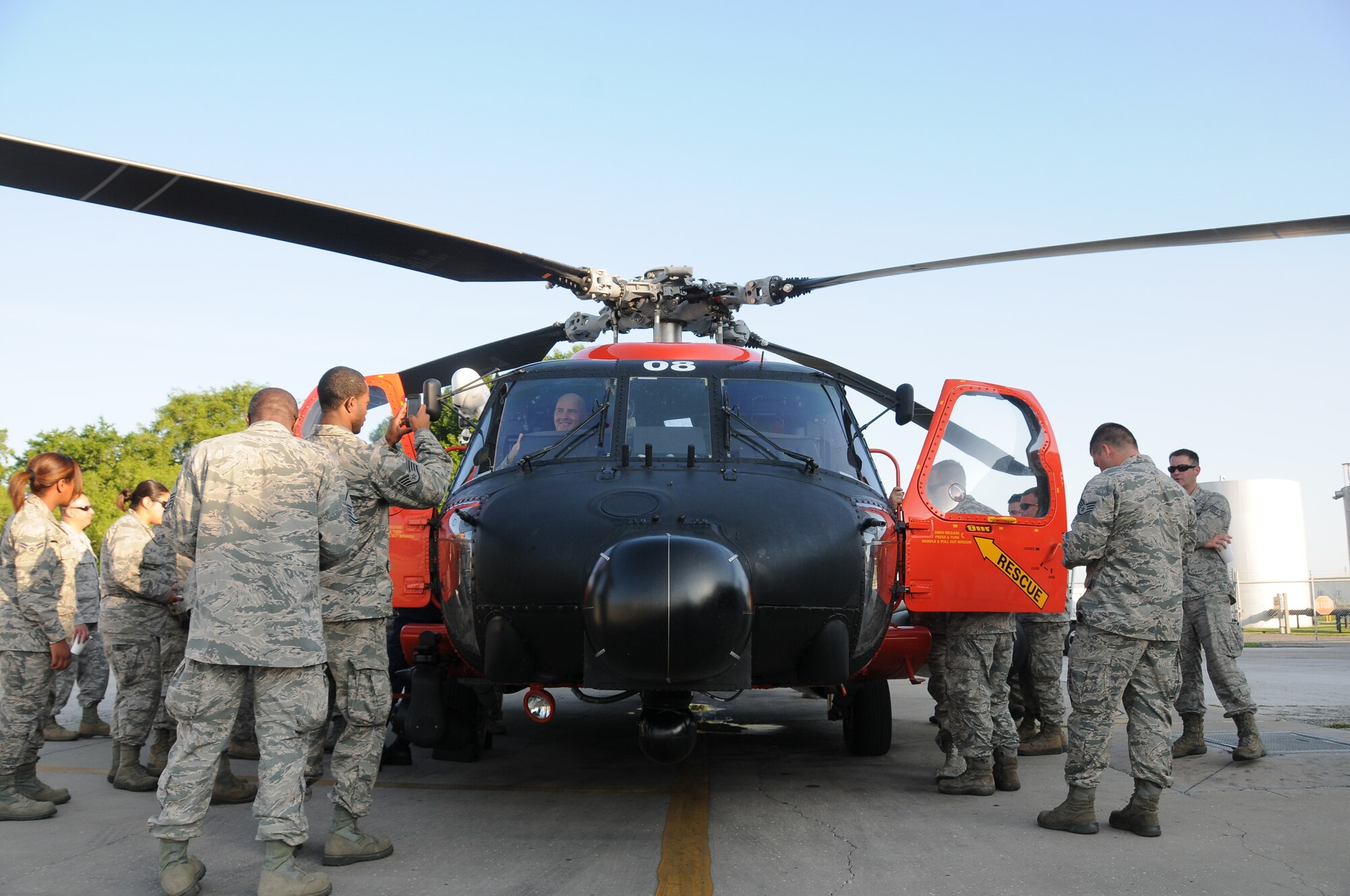 A picture of U.S. Air Force Airmen taking a look inside of an MH-60 Jayhawk helicopter.