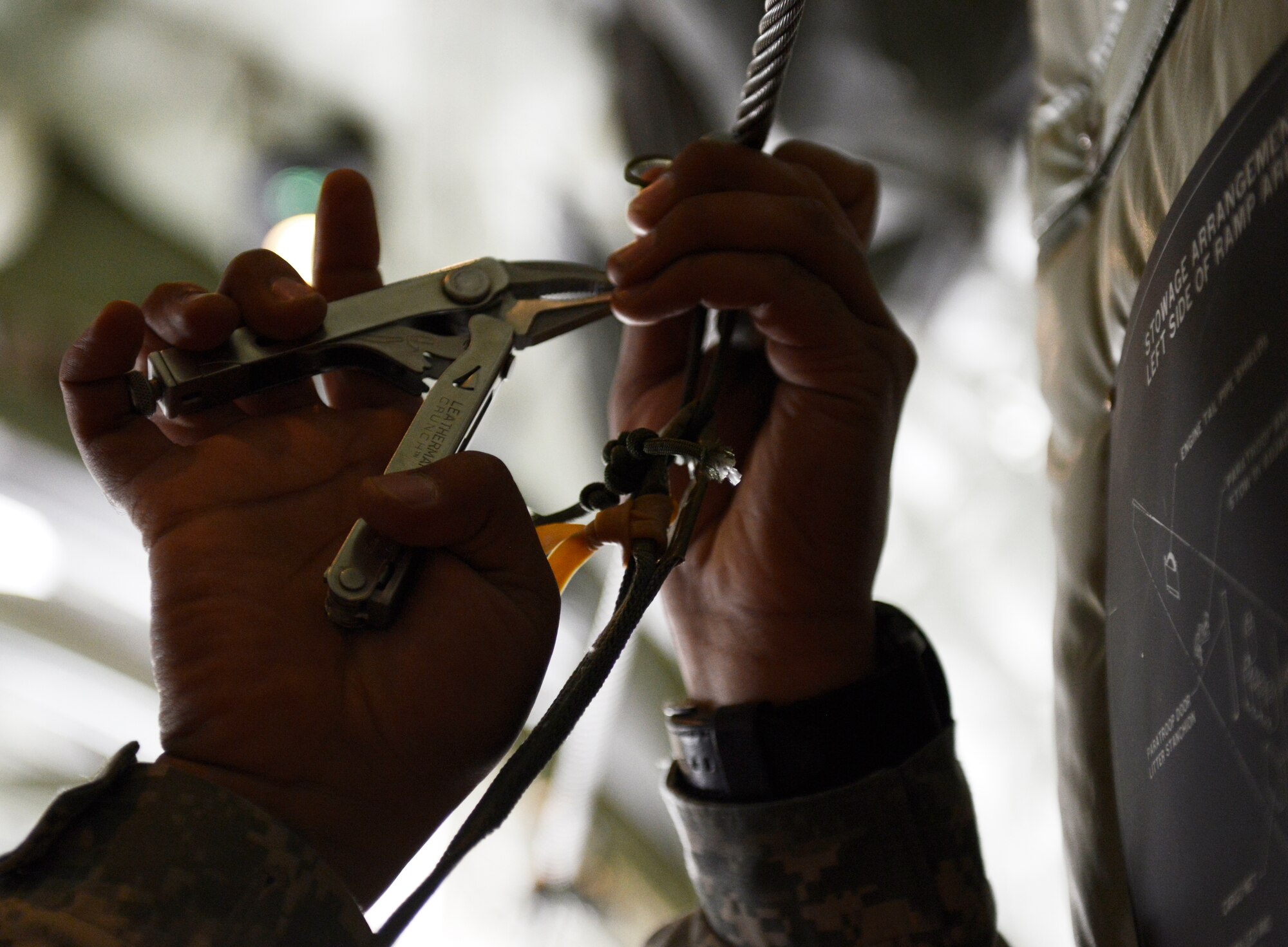 Army Staff Sgt. Neal Singh, 5th Quartermaster Company, Theatre Aerial Delivery Company, airdrop section chief, secures a pull for a parachute attached to a pallet in a C-130 Super Hercules May 27, 2015, at Ramstein Air Base, Germany. The pallet and three others were dropped over Kosovo during a training exercise with the 37th Airlift Squadron. (U.S. Air Force photo/Airman 1st Class Tryphena Mayhugh)