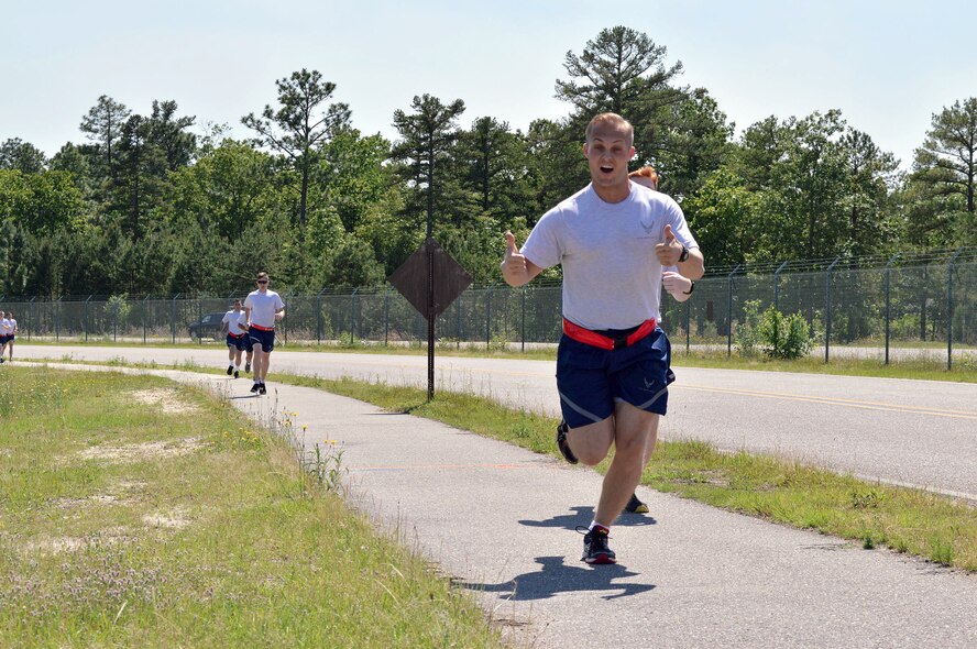 Staff Sgt. Ryan Smith, 3rd Aerial Port Squadron, participates in a memorial ‘Port Dawg’ 5K run around the Pope Field flightline May 13 honoring seven fallen air transportation Airmen who lost their lives in 2014. (U.S. Air Force photo/Marvin Krause)