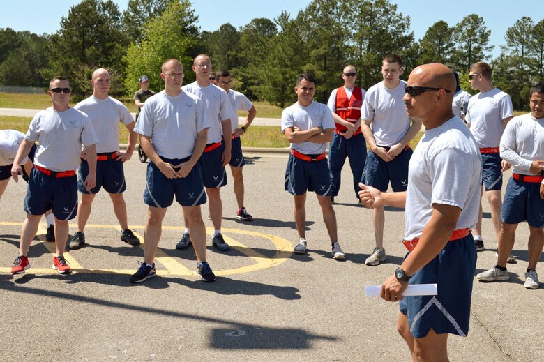 Senior Master Sgt. Andre Bellamy, 3rd Aerial Port Squadron, briefs Pope Field Airmen including members from 3rd APS prior to participating in a memorial ‘Port Dawg’ 5K run around the Pope Field flightline May 13 honoring seven fallen air transportation Airmen who lost their lives in 2014. (U.S. Air Force photo/Marvin Krause)
