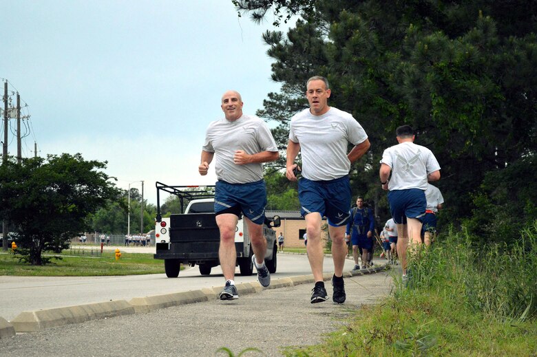 Col. Kenneth Moss, 43rd Airlift Group commander, left, and Chief Master Sgt. James Cope, 43rd Airlift Group superintendent, participate in a memorial ‘Port Dawg’ 5K run around the Pope Field flightline May 13 honoring seven fallen air transportation Airmen who lost their lives in 2014. (U.S. Air Force photo/Marvin Krause)