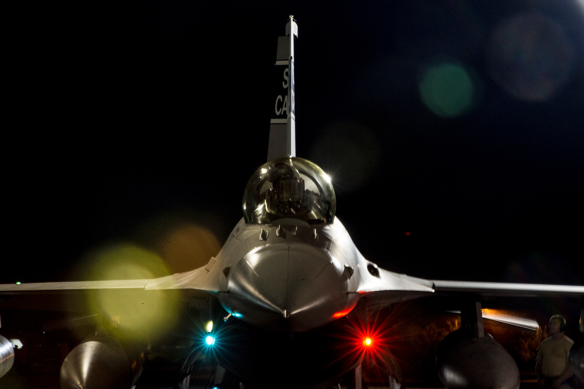 A South Air National Guard F-16 sits on the ramp prior to a night-time departure to ??ask Air Base, Poland, May 28, 2015. The 169th Fighter Wing at McEntire Joint National Guard Base, S.C., deployed F-16 Block 52 Fighting Falcons in support of Operation Atlantic Resolve training mission, called an Aviation Detachment, pairing Swamp Fox F-16 pilots and maintenance crews with their Polish Air Force counterparts at ??ask Air Base. This bilateral training, held by US Air Forces Europe and Air Forces Africa, has taken place since 2012. Through strengthened relationships and engagements with our allies, the U.S. and NATO demonstrate their shared commitment to a peaceful, stable and secure Europe. (South Carolina Air National Guard photo by Tech. Sgt. Jorge Intriago / RELEASED)