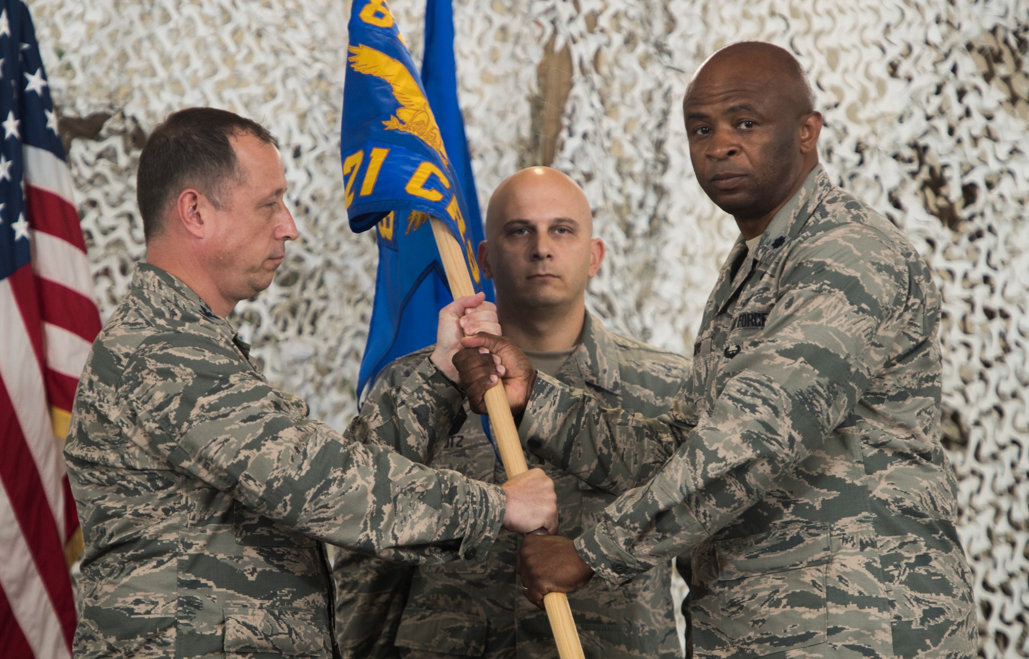 Col. Michael Frymire, 817th Contingency Response Group commander, ceremoniously hands the unit guidon of the 621st Contingency Response Squadron, the first activated unit in the 621st Contingency Response Wing reorganization, to Lt. Col. Donovan Davis, the first Commander of the 621 CRS at Joint Base McGuire-Dix-Lakehurst, N.J., May 28, 2015. The CRW will maintain the same mission to support air mobility operations worldwide. The wing is tasked with rapidly deploying its approximately 1,500 Airmen to quickly open and operate airfields, establish, expand, sustain and coordinate air mobility operations and liaise with partner nations to foster the development of their air mobility systems through education and outreach. (U.S. Air Force photo/Staff Sgt. Gustavo Gonzalez)