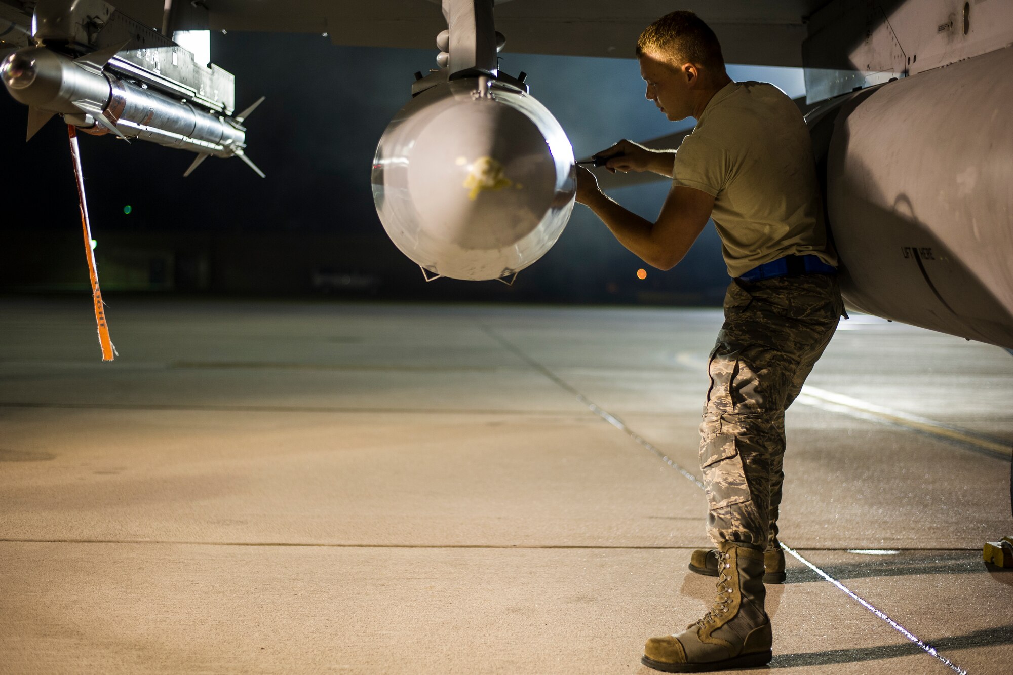 U.S. Air Force Senior Airman Aaron Carbaugh from the South Carolina Air National Guard???s 169th Fighter Wing at McEntire Joint National Guard Base, S.C., closes the latch to a storage pod on an F-16 Block 52 Fighting Falcon before its departure in support of Operation Atlantic Resolve in Poland, May 28, 2015. The training mission, called an Aviation Detachment, will pair Swamp Fox F-16 pilots and maintenance crews with their Polish Air Force counterparts at ??ask Air Base during Operation Atlantic Resolve. This bilateral training, held by U.S. Air Forces Europe and Air Forces Africa, has taken place since 2012. Through strengthened relationships and engagements with our allies, the U.S. and NATO demonstrate their shared commitment to a peaceful, stable and secure Europe. (South Carolina Air National Guard photo by Tech. Sgt. Jorge Intriago / RELEASED)
