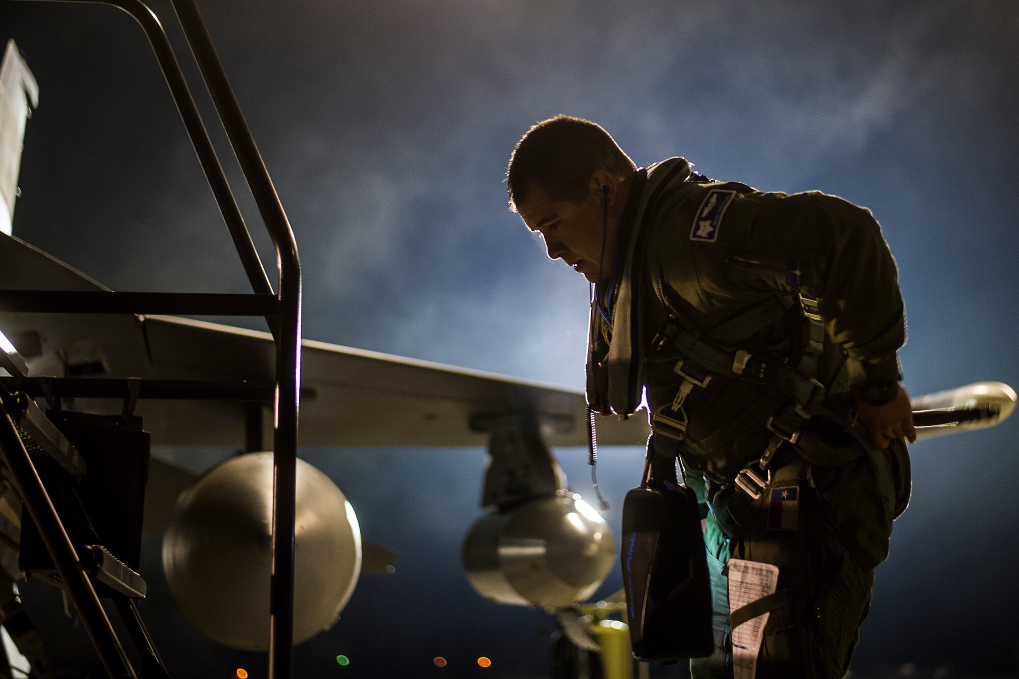 U.S. Air Force Capt. Joshua Rosecrans from the South Carolina Air National Guard???s 169th Fighter Wing at McEntire Joint National Guard Base, S.C., adjusts his flight suit before taking off for ??ask Air Base, Poland, May 28, 2015. The 169th Fighter Wing is supporting Operation Atlantic Resolve in Poland, The training mission, called an Aviation Detachment, will pair Swamp Fox F-16 pilots and maintenance crews with their Polish Air Force counterparts at during Operation Atlantic Resolve. This bilateral training, held by US Air Forces Europe and Air Forces Africa, has taken place since 2012. Through strengthened relationships and engagements with our allies, the U.S. and NATO demonstrate their shared commitment to a peaceful, stable and secure Europe. (South Carolina Air National Guard photo by Tech. Sgt. Jorge Intriago / RELEASED)