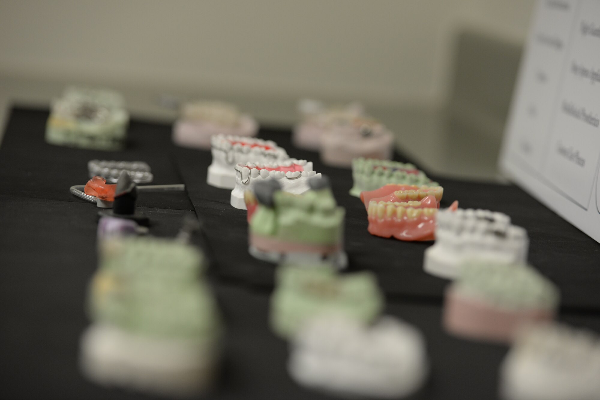 Dental molds sit on a table in the 18th Dental Squadron’s area dental lab on Kadena Air Base, Japan, May 29, 2015. The 18th DS is home to the second-largest Area Dental Lab in the Air Force, which produces prosthetic devices such as dental crowns, night guards and dentures to the patients of more than 200 doctors across the Pacific Command. (U.S. Air Force photo by Senior Airman Omari Bernard)