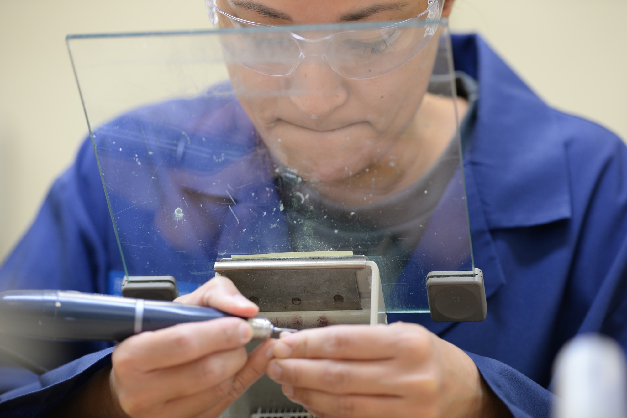 U.S. Air Force Staff Sgt. Kimberly Duenas, 18th Dental Squadron dental lab technician, fabricates a dental implant on Kadena Air Base, Japan, May 29, 2015. The 18th DS’s Area Dental Lab processes about 100 prosthetic devices such as dentures and retainers every month, and supports more than 50 Pacific Command dental facilities. (U.S. Air Force photo by Senior Airman Omari Bernard)