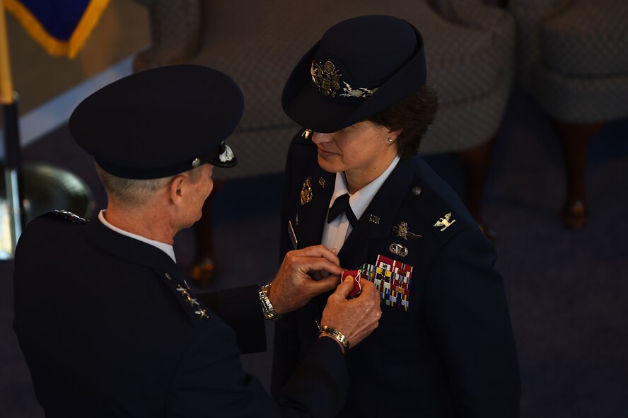 U.S. Air Force Lt. Gen. Darryl Roberson, 3rd Air Force and 17th Expeditionary Air Force commander, left, presents Col. Angela Cadwell with the Legion of Merit decoration, during the wing change of command ceremony at RAF Alconbury, England, May 28, 2015, for her exemplary service as commander of the 501st Combat Support Wing. Established Sept. 8, 1939 by presidential proclamation, the decoration may be conferred on officers and enlisted Service members who distinguished themselves by exceptionally meritorious conduct in the performance of outstanding services. (U.S. Air Force photo by Staff Sgt. Jarad A. Denton/Released)