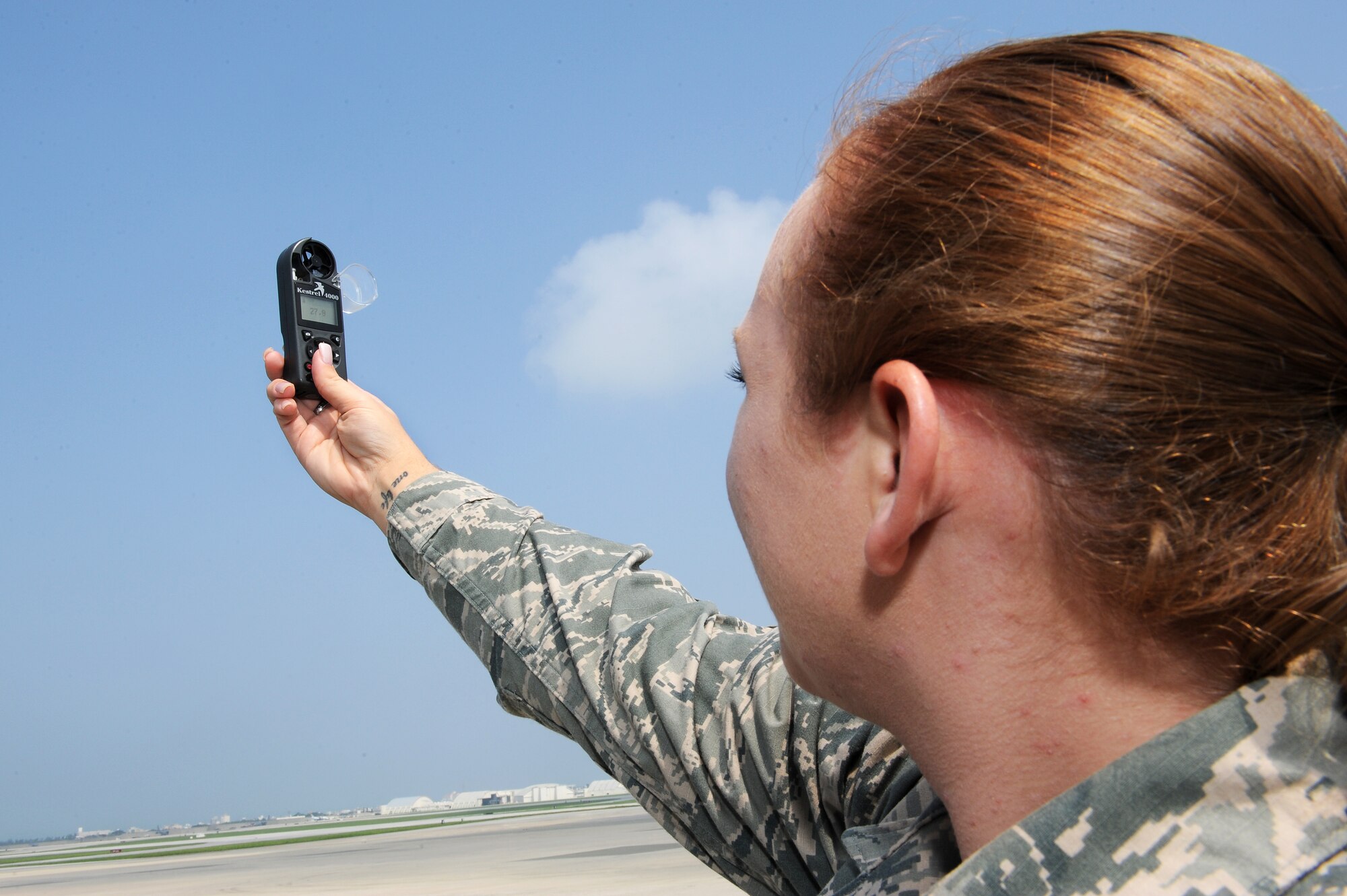 U.S. Air Force Staff Sgt. Hailey Thompson, 18th Operations Support Squadron weather technician, meters weather conditions on Kadena Air Base, Japan, May 29, 2015. In the event of an automated weather sensor malfunctioning, 18th OSS weather flight personnel use handheld meters in order to provide accurate weather updates every eight hours. (U.S. Air Force photo by Airman 1st Class Zade C. Vadnais)