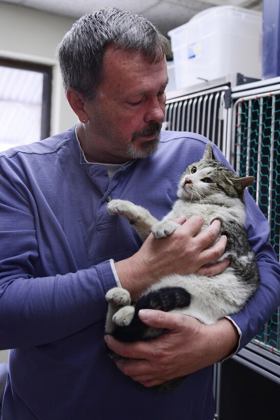 Tim Blake, Homeward Bound Osan Animal Shelter president, holds Tucker, Homeward Bound Osan Animal Shelter resident, March 11, 2014, at Osan Air Base, Republic of Korea. The shelter is only capable of housing cats and dogs at this time. (U.S. Air Force photo by Senior Airman Matthew Lancaster)