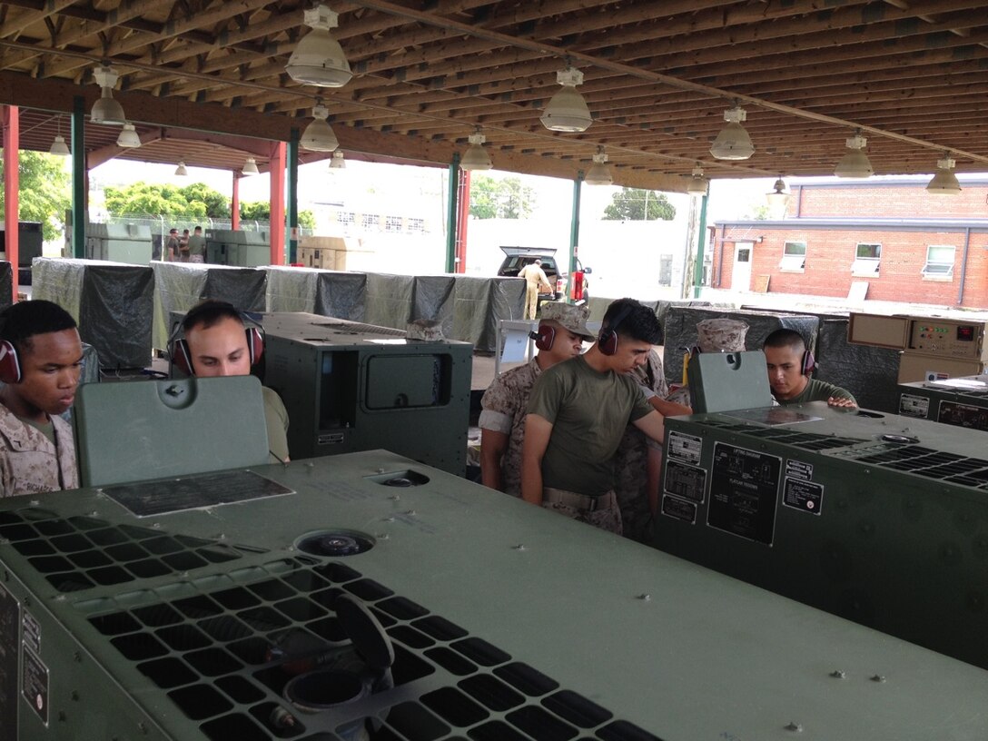 Marines conduct practical application on paralleling generator sets.