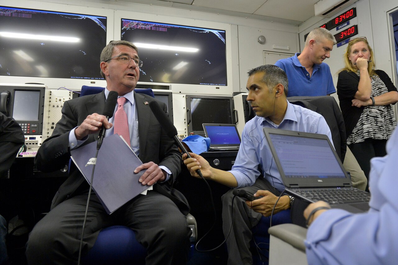 Defense Secretary Ash Carter holds an in-flight briefing on his way from Hawaii to Singapore. Carter attended the U.S. Pacific Command and U.S. Pacific Fleet change-of-command ceremonies in Honolulu, May 27, 2015.  The secretary is on a 10-day trip to advance the next phase of the Asia-Pacific rebalance. DoD photo by Glenn Fawcett 