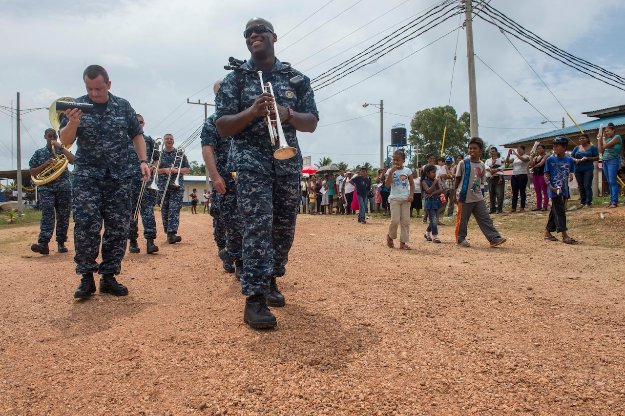 U.S. Navy Petty Officer 2nd Class Vincent Moody and other members of the U.S. Fleet Forces Band ensemble Uncharted Waters walk with area residents in Puerto Cabezas, Nicaragua, May 22, 2015, before a performance during Continuing Promise 2015. U.S. Navy photo by Petty Officer 2nd Class Brittney Cannady